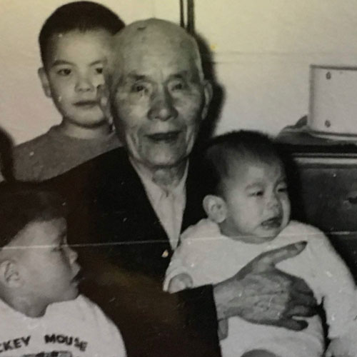MAH Look sitting, holding grandson Stuart Mah, 1961